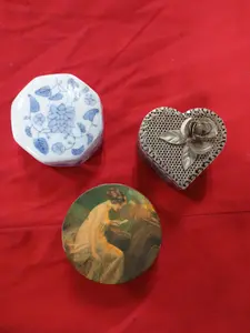 A Collection of Decorative Trinket Boxes and a Carved Bead