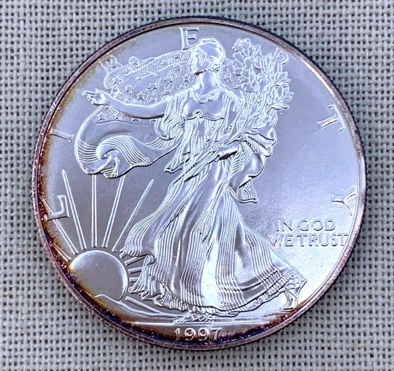Toned Brilliant Uncirculated 1997 American Eagle Silver Dollar Coin from auction in Dundee, Ohio — image 47