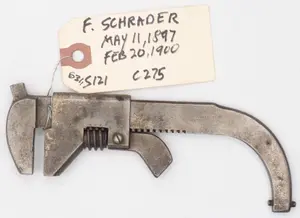 E. Schrader with nub on jaw