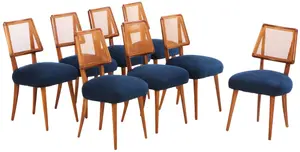 EIGHT MID CENTURY DINING CHAIRS HAVING NEWLY UPHOLSTERED SEATS AND CANTED CANE BACKS C 1950.