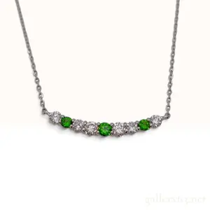 A Platinum Demantoid Garnet and Diamond Curved Bar Necklace