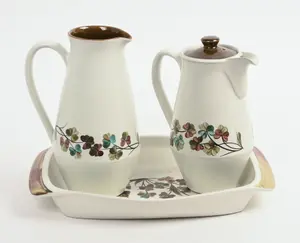 TWO DENBY PORCELAIN PITCHERS AND A DISH.