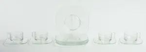 FOUR JOE COLOMBO GLASS PLATES, TEACUPS AND SAUCERS.