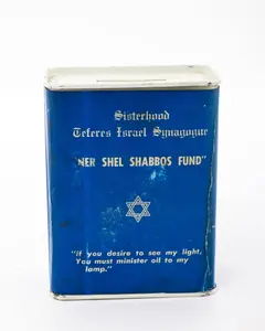 A TIN CHARITY CONTAINER COLLECTING FUNDS FOR THE TEFERRES ISRAEL SYNAGOGUE.