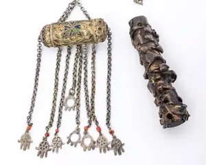 AN AMULET HOLDER AND A MEZUZAH CASE