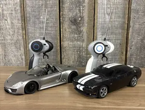 Two Auldey Remote Controlled Toy Cars with Transmitters