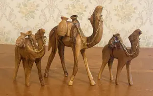 A Trio of Graduated Hand Carved Olive Wood Camel Figurines