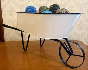 Large Decorative White Metal Wheelbarrow with Assortment of Fabric Rag Balls