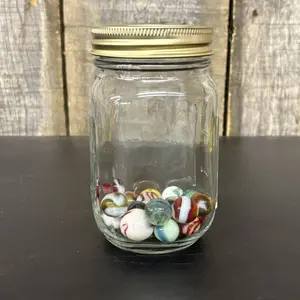 A Collection of Vintage Glass Marbles in a Glass Mason Jar