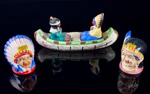 A Set of Four Japanese Hand Painted Ceramic Native American Souvenir Salt and Pepper Shakers and Canoe Base