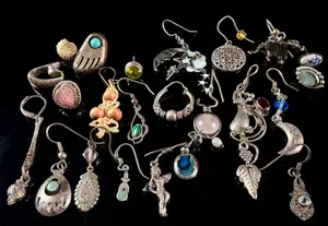 An Assortment of Sterling Silver Single Earrings and Charms with Gemstones