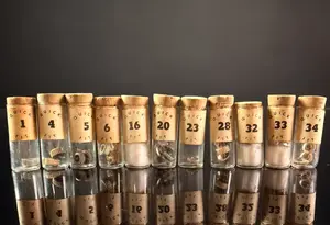 An Assortment of Vintage Quick Fit Watch Winding Crowns in Numbered Glass Vials